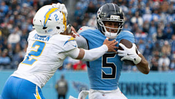 Nov 2, 2025; Nashville, Tennessee, USA; Tennessee Titans wide receiver Elic Ayomanor (5) stiff arms Los Angeles Chargers cornerback Elijah Molden (2)  during the first half at Nissan Stadium. Mandatory Credit: Steve Roberts-Imagn Images