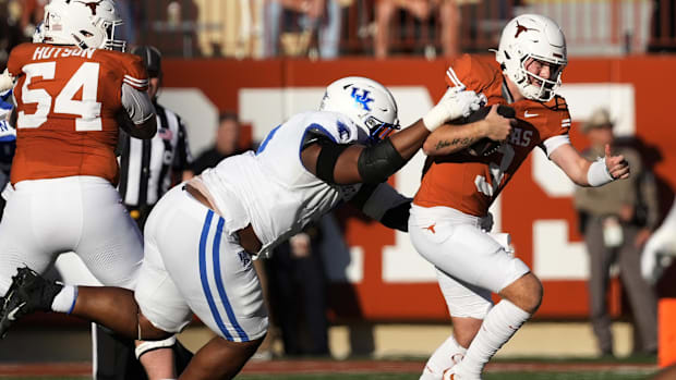 Nov 23, 2024; Austin, Texas, USA; Texas Longhorns quarterback Quinn Ewers (3) tries to avoid a sack by Kentucky Wildcats defe