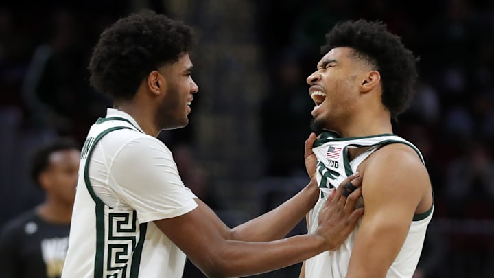 Michigan State Spartans guard Jaden Akins, right, is congratulated by guard Jase Richardson (11) after a dunk during the second half of an NCAA Tournament First Round game against the Bryant University Bulldogs at Rocket Arena on Saturday, March 22, 2025, in Cleveland, Ohio.