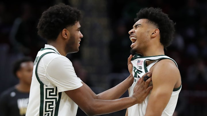 Michigan State Spartans guard Jaden Akins, right, is congratulated by guard Jase Richardson (11) after a dunk during the second half of an NCAA Tournament First Round game against the Bryant University Bulldogs at Rocket Arena on Saturday, March 22, 2025, in Cleveland, Ohio.