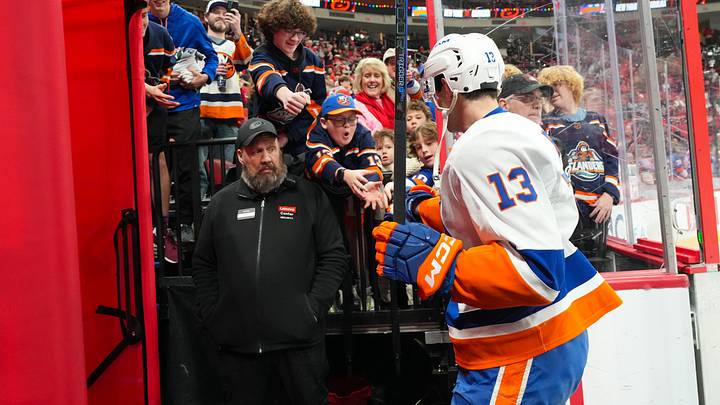 Dec 17, 2024; Raleigh, North Carolina, USA;  New York Islanders center Mathew Barzal (13) give a puck to the fans for the warmups before the game against the Carolina Hurricanes at Lenovo Center.