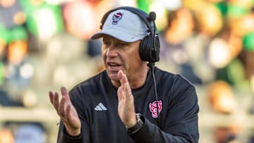 Oct 11, 2025; South Bend, Indiana, USA; NC State Wolfpack head coach Dave Doeren claps as he walks onto the field against the Notre Dame Fighting Irish during the second half at Notre Dame Stadium. Mandatory Credit: Michael Caterina-Imagn Images