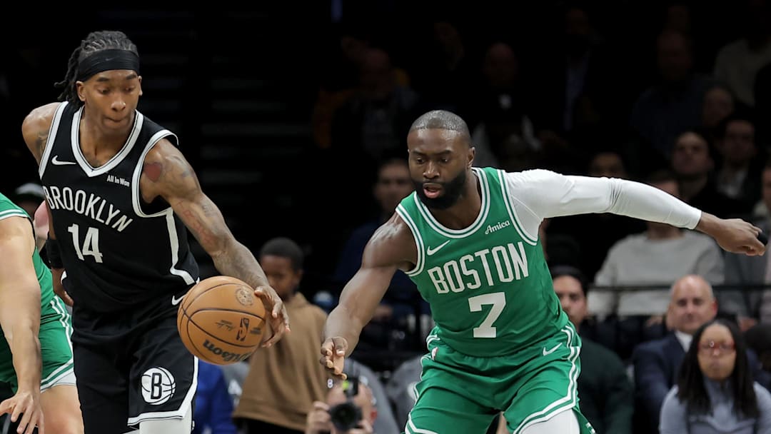 Nov 18, 2025; Brooklyn, New York, USA; Brooklyn Nets guard Terance Mann (14) controls the ball against Boston Celtics center Luka Garza (52) and guard Jaylen Brown (7) during the first quarter at Barclays Center. Mandatory Credit: Brad Penner-Imagn Images