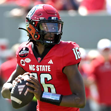 Sep 28, 2024; Raleigh, North Carolina, USA;  North Carolina State Wolfpack quarter back CJ Bailey (16) looks for an opening for a throw against the Northern Illinois Huskies at Carter-Finley Stadium. Mandatory Credit: Zachary Taft-Imagn Images