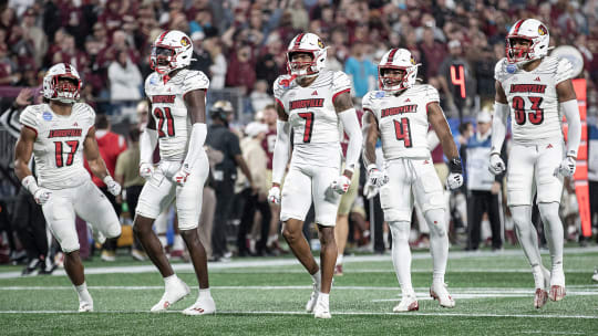 The Louisville defense celebrated after sacking FSU punter Alex Mastromanno (29) as the Louisville Cardinals faced off against the Florida State Seminoles at Bank of America Field in Charlotte, NC.