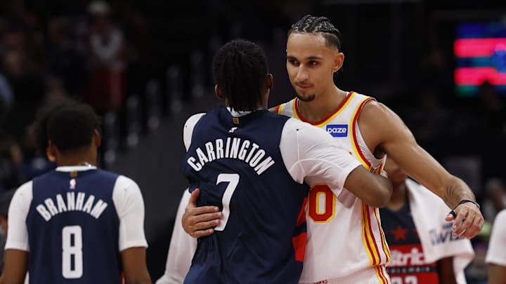 Nov 25, 2025; Washington, District of Columbia, USA; Washington Wizards guard Bub Carrington (7) hugs Atlanta Hawks forward Zaccharie Risacher (10) after their game at Capital One Arena. Mandatory Credit: Geoff Burke-Imagn Images