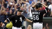 Chicago White Sox starting pitcher Mark Buehrle (56) celebrates with teammate Josh Fields (7) after throwing a perfect game against the Tampa Bay Rays.