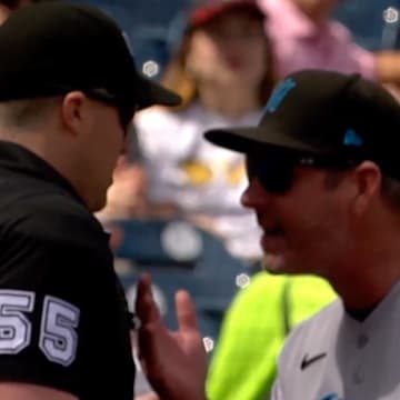 Clayton McCollough gives umpire Brennan Miller a piece of his mind.