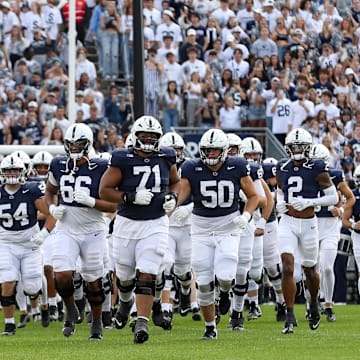 The Penn State Nittany Lions run onto the field prior to the game against the Bowling Green Falcons at Beaver Stadium.