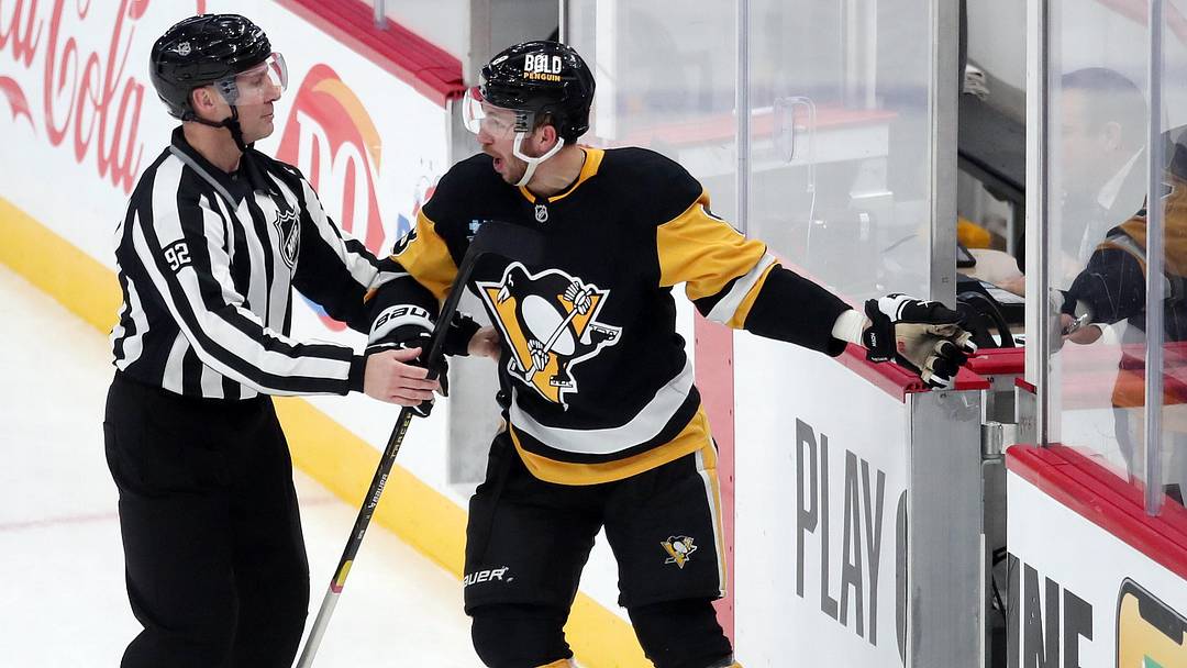 Jan 9, 2025; Pittsburgh, Pennsylvania, USA;  NHL linesman Mark Shewchyk (92) escorts Pittsburgh Penguins left wing Michael Bunting (8) to the penalty box as Bunting protests against the Edmonton Oilers during the third period at PPG Paints Arena. Mandatory Credit: Charles LeClaire-Imagn Images