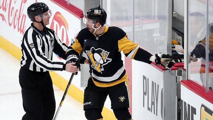 Jan 9, 2025; Pittsburgh, Pennsylvania, USA;  NHL linesman Mark Shewchyk (92) escorts Pittsburgh Penguins left wing Michael Bunting (8) to the penalty box as Bunting protests against the Edmonton Oilers during the third period at PPG Paints Arena. Mandatory Credit: Charles LeClaire-Imagn Images