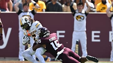 Oct 5, 2024; College Station, Texas, USA; Texas A&M Aggies defensive lineman Rylan Kennedy (15) tackles Missouri Tigers wide receiver Marquis Johnson (2) in the third quarter at Kyle Field. Mandatory Credit: Maria Lysaker-Imagn Images. 