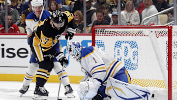 Oct 16, 2024; Pittsburgh, Pennsylvania, USA; Buffalo Sabres goaltender Ukko-Pekka Luukkonen (1) makes a save against Pittsburgh Penguins right wing Bryan Rust (17) during the third period at PPG Paints Arena. Mandatory Credit: Charles LeClaire-Imagn Images