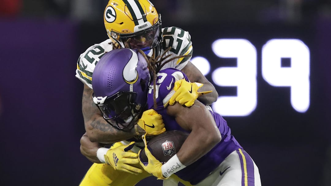 Minnesota Vikings running back Aaron Jones (33) gains a first down on a reception against Green Bay Packers cornerback Keisean Nixon (25) in the third quarter at U.S. Bank Stadium.