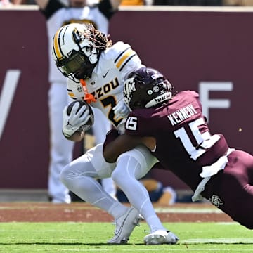 Oct 5, 2024; College Station, Texas, USA; Texas A&M Aggies defensive lineman Rylan Kennedy (15) tackles Missouri Tigers wide receiver Marquis Johnson (2) in the third quarter at Kyle Field. Mandatory Credit: Maria Lysaker-Imagn Images. 