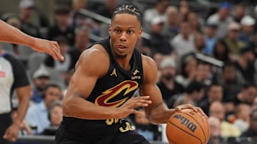 Apr 4, 2025; San Antonio, Texas, USA;  Cleveland Cavaliers forward Isaac Okoro (35) dribbles against San Antonio Spurs forward Keldon Johnson (0) in the first half at Frost Bank Center. Mandatory Credit: Daniel Dunn-Imagn Images