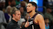 Nov 21, 2025; Phoenix, Arizona, USA; Phoenix Suns head coach Jordan Ott (left) with guard Devin Booker (1) against the Minnesota Timberwolves in the second half of an NBA Cup game at Mortgage Matchup Center. Mandatory Credit: Mark J. Rebilas-Imagn Images