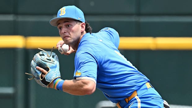 UCLA Bruins shortstop Roch Cholowsky (1) completes a double play 