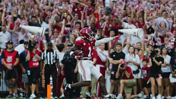 Aug 31, 2024; Tuscaloosa, Alabama, USA; Alabama Crimson Tide wide receiver Kendrick Law (1) scores a touchdown against the Western Kentucky Hilltoppers during the first quarter at Bryant-Denny Stadium. Mandatory Credit: Will McLelland-Imagn Images