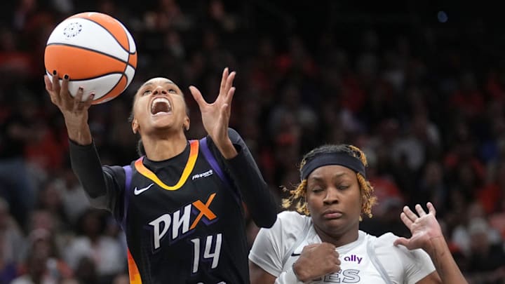 Phoenix Mercury forward DeWanna Bonner (14) shoots the ball while being fouled by Las Vegas Aces forward NaLyssa Smith (3) during Game 3 of the WNBA Finals at Mortgage Matchup Center in Phoenix on Oct. 8, 2025.
