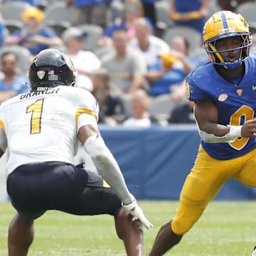 Aug 31, 2024; Pittsburgh, Pennsylvania, USA;  Pittsburgh Panthers running back Desmond Reid (0) runs after a catch against Kent State Golden Flashes safety Alex Branch (1) during the second quarter at Acrisure Stadium. Mandatory Credit: Charles LeClaire-Imagn Images