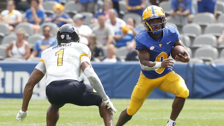 Aug 31, 2024; Pittsburgh, Pennsylvania, USA;  Pittsburgh Panthers running back Desmond Reid (0) runs after a catch against Kent State Golden Flashes safety Alex Branch (1) during the second quarter at Acrisure Stadium. Mandatory Credit: Charles LeClaire-Imagn Images