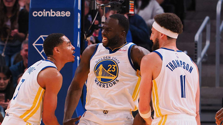 Apr 18, 2022; San Francisco, California, USA; Golden State Warriors forward Draymond Green (23) celebrates with guard Jordan Poole (3) and guard Klay Thompson (11) after a foul against the Denver Nuggets during the second quarter of game two of the first round for the 2022 NBA playoffs at Chase Center. 