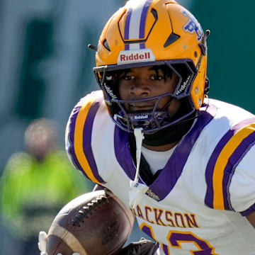 Jackson's Ezavier Crowell (13) tries to evade a tackle by Cherokee County's Tyson Wood (8) at Protective Stadium in the AHSAA 4A State Championship game.