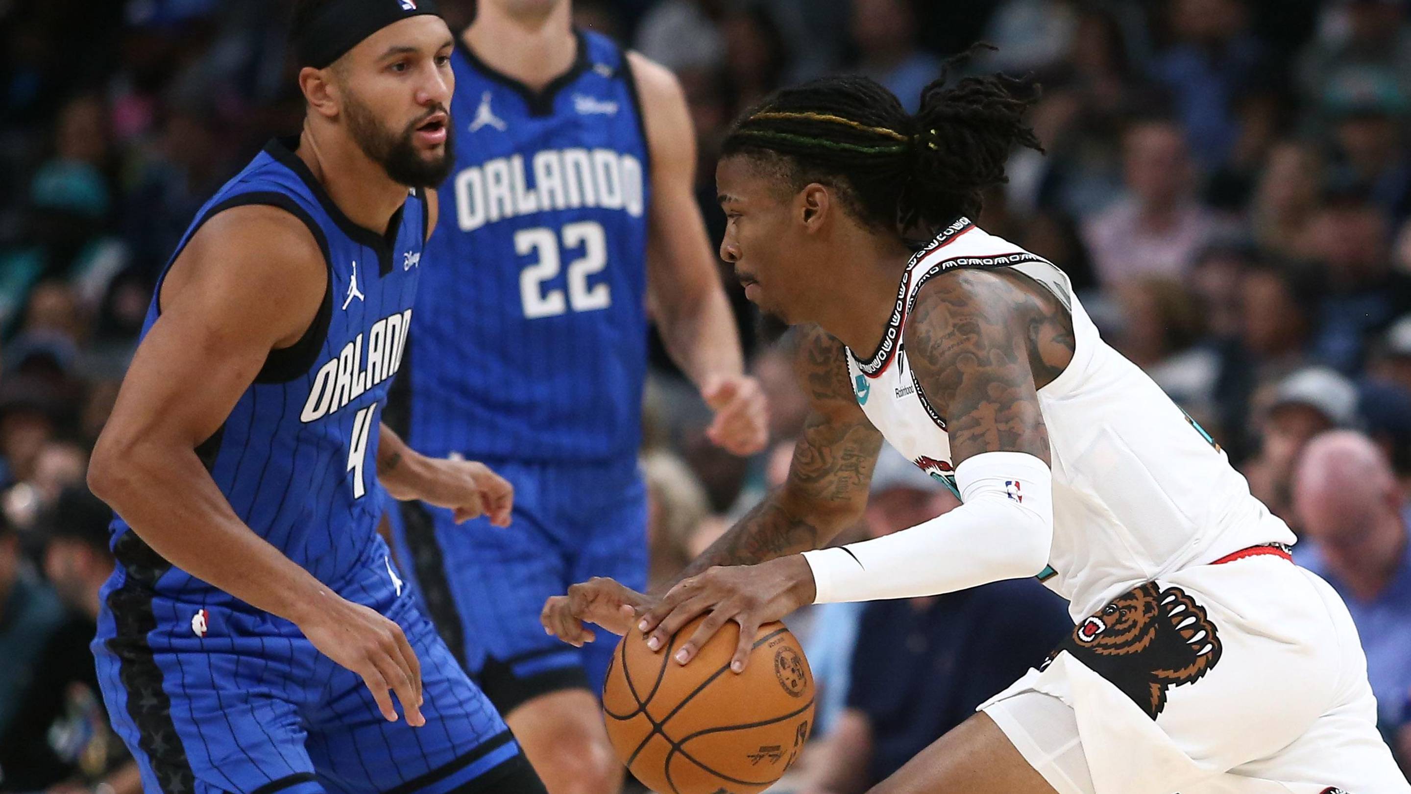 Oct 26, 2024; Memphis, Tennessee, USA; Memphis Grizzlies guard Ja Morant (12) drives to the basket as Orlando Magic guard Jalen Suggs (4) defends during the second half at FedExForum. Mandatory Credit: Petre Thomas-Imagn Images