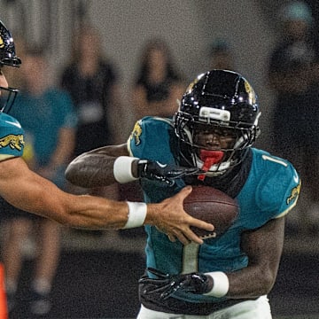 Jacksonville Jaguars quarterback Trevor Lawrence (16) hands off Jacksonville Jaguars running back Travis Etienne (1) during a Monday Night NFL football game at EverBank Stadium, Monday, Oct. 6, 2025, in Jacksonville, Fla. [Doug EngleFlorida Times-Union]