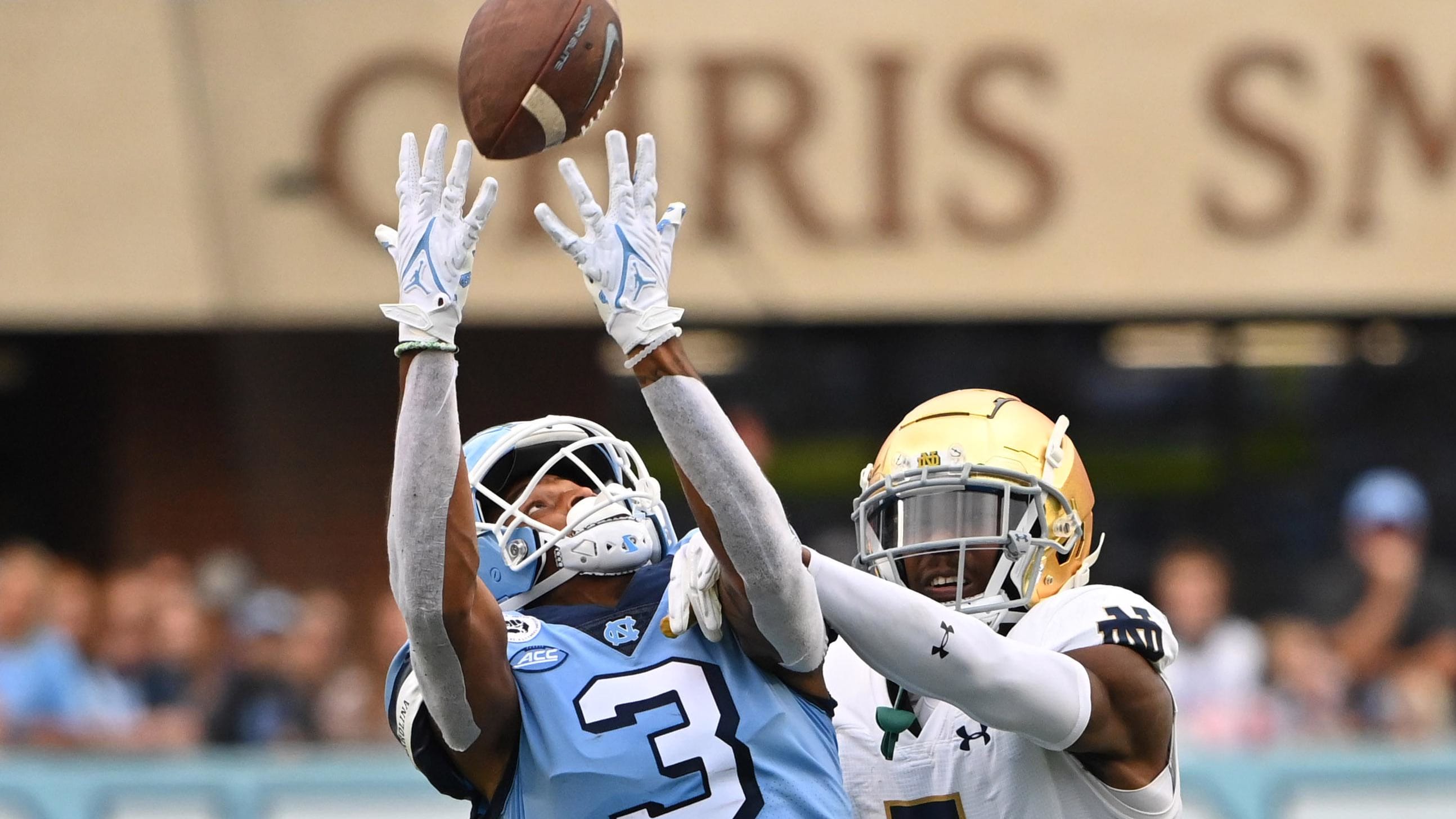 Notre Dame's Cam Hart closes in to break up a pass to North Carolina receiver Antoine Green.