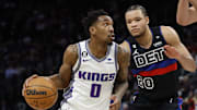 Dec 16, 2022; Detroit, Michigan, USA;  Sacramento Kings guard Malik Monk (0) dribbles defended by Detroit Pistons forward Kevin Knox II (20) in the first half at Little Caesars Arena. Mandatory Credit: Rick Osentoski-Imagn Images