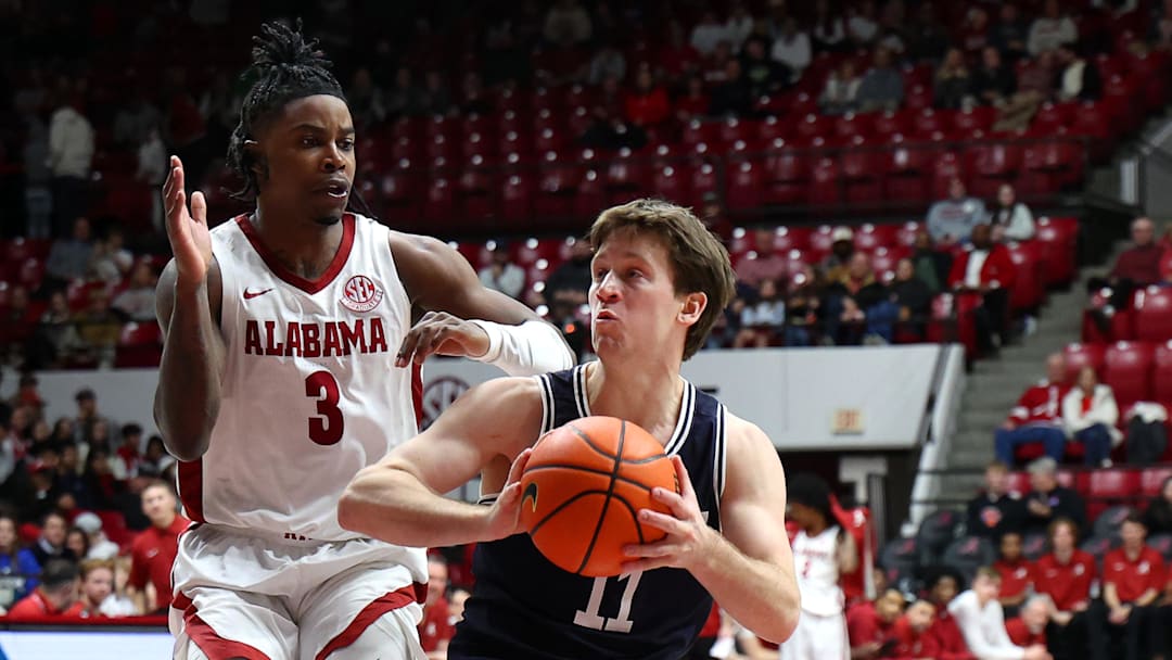 Dec 29, 2025; Tuscaloosa, Alabama, USA; Yale Bulldogs guard Trevor Mullin (11) drives to the basket against Alabama Crimson Tide guard Latrell Wrightsell Jr. (3) during the second half at Coleman Coliseum. Mandatory Credit: David Leong-Imagn Images