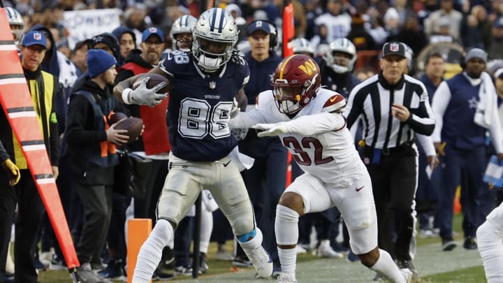 Jan 7, 2024; Landover, Maryland, USA; Dallas Cowboys wide receiver CeeDee Lamb (88) is pushed out of bounds after making a catch by Washington Commanders safety Terrell Burgess (32) during the first quarter at FedExField. Mandatory Credit: Geoff Burke-USA TODAY Sports