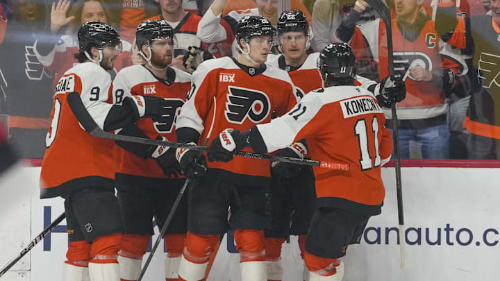 May 9, 2026; Philadelphia, Pennsylvania, USA; Philadelphia Flyers left wing Alex Bump (20) celebrates a goal with teammates against the Carolina Hurricanes in game four of the second round of the 2026 Stanley Cup Playoffs at Xfinity Mobile Arena.