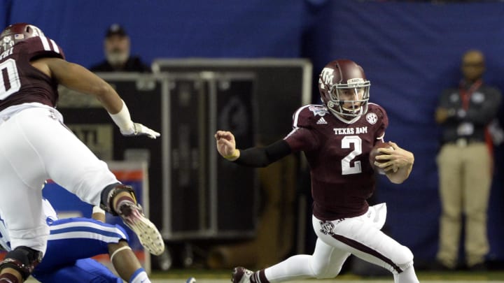 Dec 31, 2013; Atlanta, GA, USA; Texas A&M Aggies quarterback Johnny Manziel (2) carries the ball against the Duke Blue Devils during the second quarter in the 2013 Chick-fil-a Bowl at the Georgia Dome. Mandatory Credit: John David Mercer-USA TODAY Sports