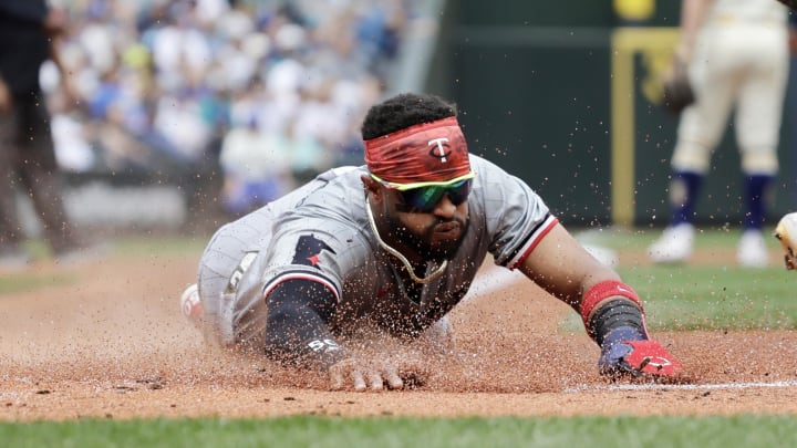 Jun 30, 2024; Seattle, Washington, USA; Minnesota Twins shortstop Willi Castro (50) dives in to score against the Seattle Mariners during the first inning at T-Mobile Park. Mandatory Credit: John Froschauer-USA TODAY Sports