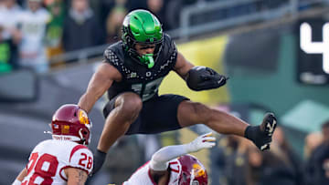 Oregon tight end Kenyon Sadiq hurdles over USC cornerback DeCarlos Nicholson as the Oregon Ducks host the USC Trojans on Nov. 22, 2025, at Autzen Stadium in Eugene, Oregon.