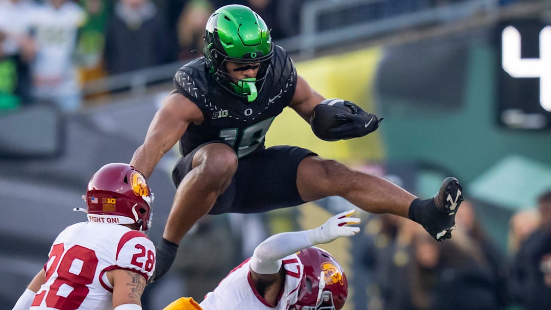 Oregon tight end Kenyon Sadiq hurdles over USC cornerback DeCarlos Nicholson as the Oregon Ducks host the USC Trojans on Nov. 22, 2025, at Autzen Stadium in Eugene, Oregon.