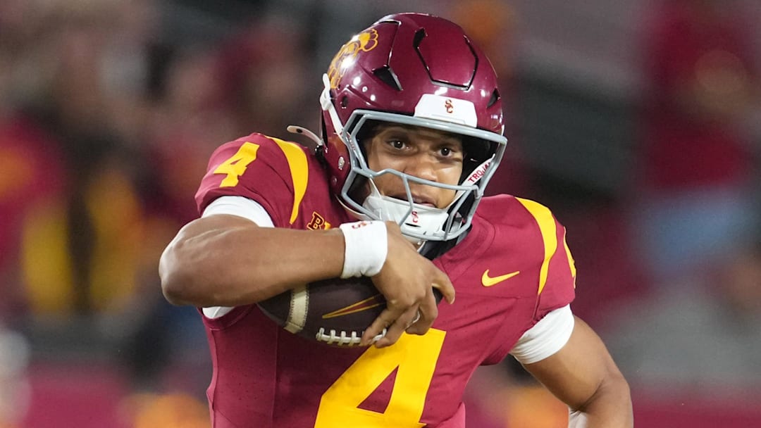 Aug 30, 2025; Los Angeles, California, USA; Southern California Trojans quarterback Husan Longstreet (4) carries the ball against Missouri State Bears cornerback Navonn Barrett (5) in the second half at United Airlines Field at Los Angeles Memorial Coliseum. Mandatory Credit: Kirby Lee-Imagn Images