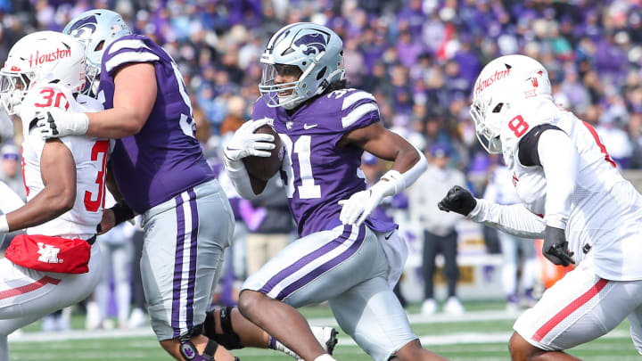 Oct 28, 2023; Manhattan, Kansas, USA; Kansas State Wildcats running back DJ Giddens (31) runs away from Houston Cougars linebacker Malik Robinson (8) during the third quarter at Bill Snyder Family Football Stadium. Mandatory Credit: Scott Sewell-USA TODAY Sports