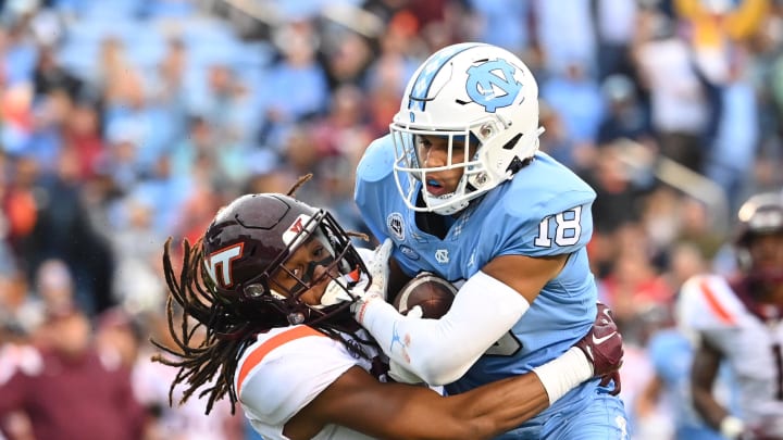 Oct 1, 2022; Chapel Hill, North Carolina, USA; North Carolina Tar Heels tight end Bryson Nesbit (18) makes a catch as Virginia Tech Hokies defensive back Jalen Stroman (26) defends in the third quarter at Kenan Memorial Stadium. Mandatory Credit: Bob Donnan-USA TODAY Sports