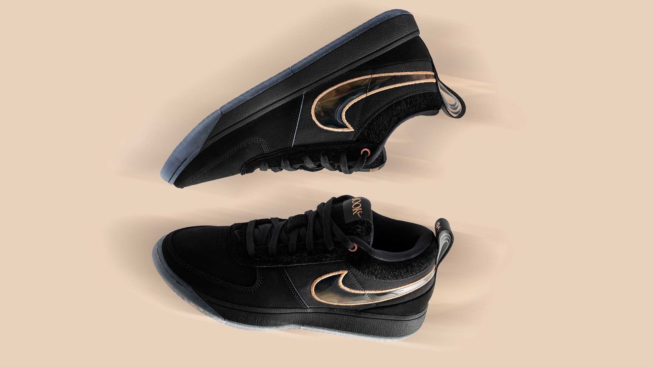 Side view of Devin Booker's black and bronze Nike sneakers.