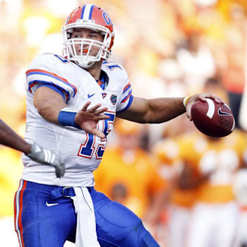 September 20, 2008;  Knoxville, TN, USA;  Florida Gators quarterback Tim Tebow (15) throws a touchdown pass to wide receiver Percy Harvin (not pictured) over top of Tennessee Volunteers defensive lineman Ben Martin (99) in the second half at Neyland Stadium. The Gators defeated the Volunteers 30-6. Mandatory Credit: Dale Zanine- Imagn Images