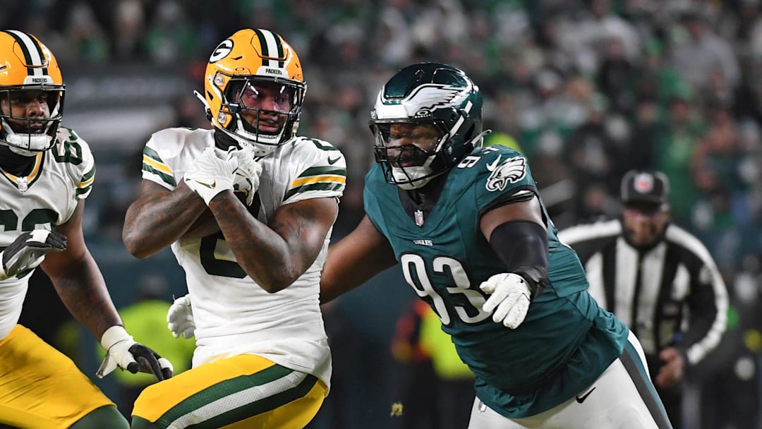 Green Bay Packers running back Josh Jacobs (8) is tackled by Philadelphia Eagles defensive tackle Milton Williams.