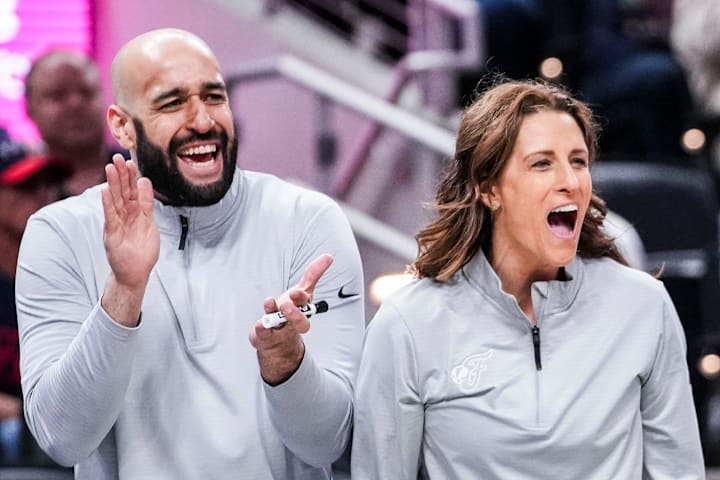 Indiana Fever assistant Austin Kelly and head coach Stephanie White celebrate during a game against the Washington Mystics.
