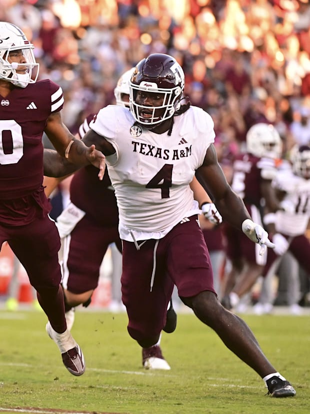 Mississippi State Bulldogs QB Michael Van Buren Jr. drops back to pass against Texas A&M Aggies DL Shemar Stewart.