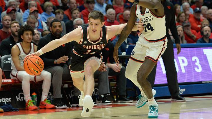 Feb 27, 2024; Dayton, Ohio, USA;  Davidson Wildcats guard Angelo Brizzi (14) battles against Dayton Flyers guard Kobe Elvis (24) during the first half of the game at University of Dayton Arena. Mandatory Credit: Matt Lunsford-USA TODAY Sports