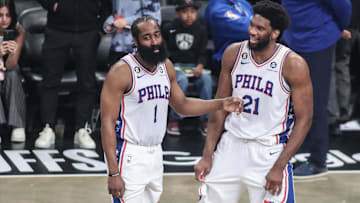 Philadelphia 76ers guard James Harden talks with center Joel Embiid during an official review.