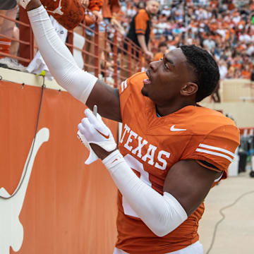 April 20, 2024; Austin, Texas, USA: Texas Orange team defensive back Terrance Brooks (8) signs autographs for fans while visiting for the Longhorns' spring Orange and White game at Darrell K Royal Texas Memorial Stadium. Mandatory Credit: Sara Diggins-Imagn Images via American Statesman